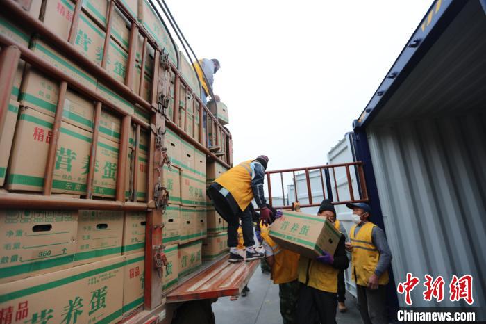 圖為鐵路裝卸作業(yè)人員正在將云南特色農(nóng)產(chǎn)品裝入集裝箱?！詈?攝